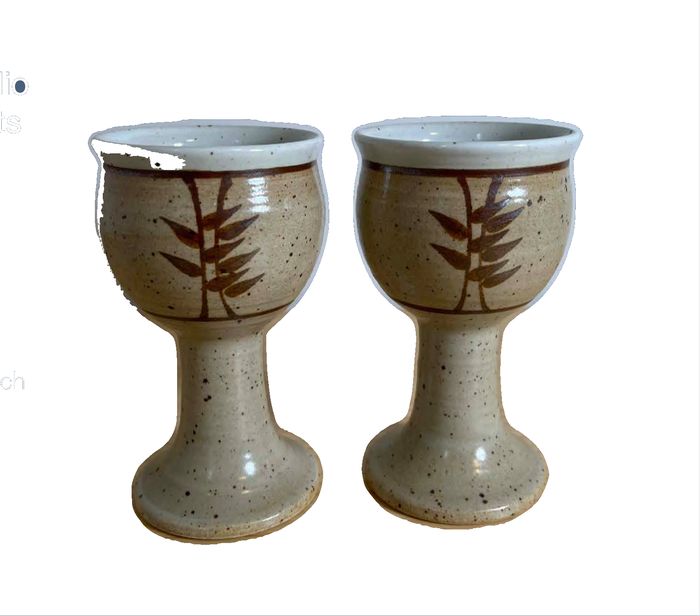 Pair of hand-thrown studio pottery stoneware goblets with painted leaf motifs